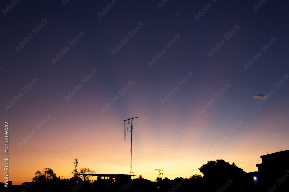 Twilight sky with silhouette of a tree and a power pole. Twilight sky with silhouette of a tree and a power pole.