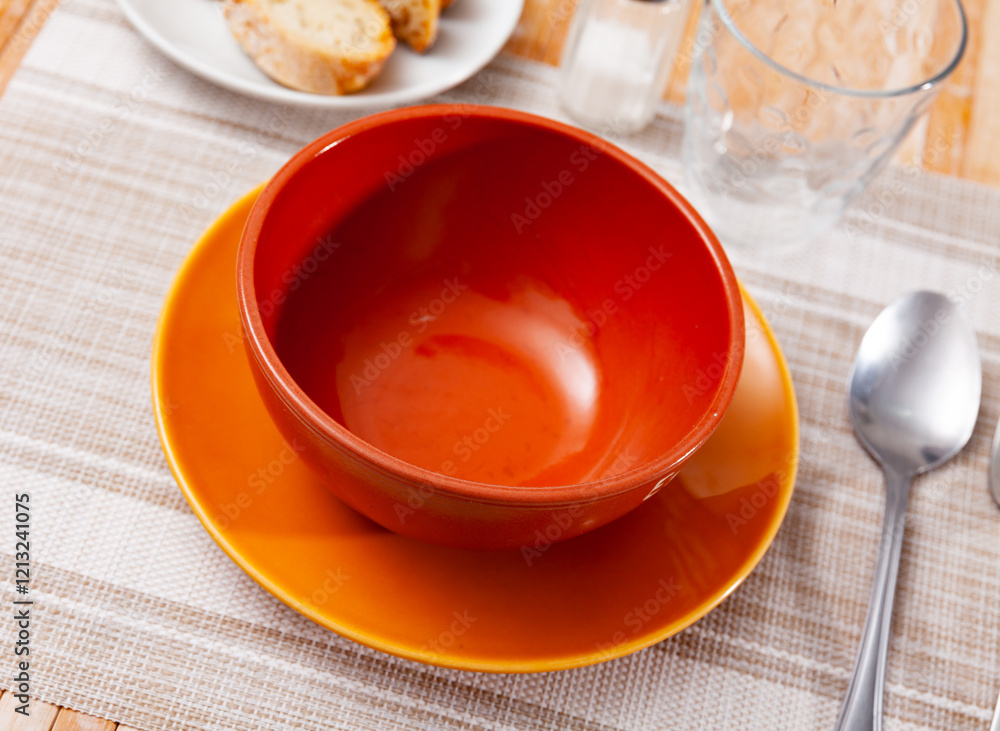 Plate or bowl for soup and cutlery on a holiday table Plate or bowl for soup and cutlery on a holiday table