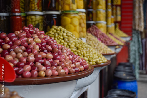 Different Olives displayed in local market with pickle jars in background