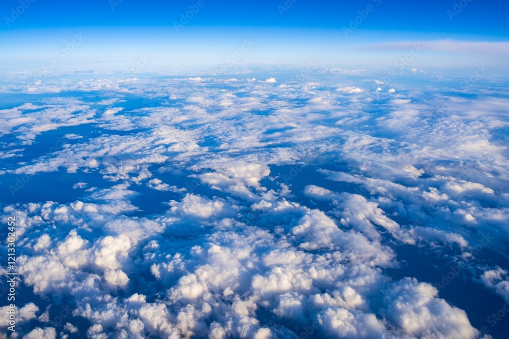 Vast cloud formations above the serene ocean captured during daylight from an aerial perspective