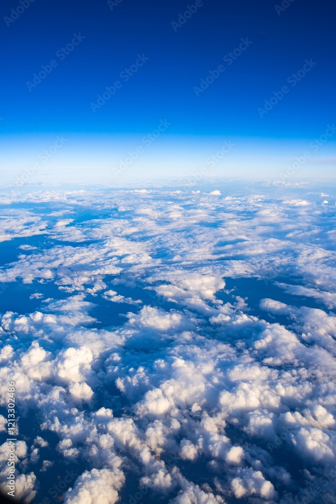 Clouds and blue sky viewed from high altitude during daytime over the ocean