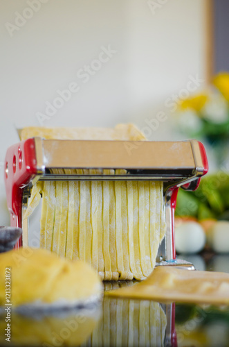 The fresh pasta and machine on kitchen table home made
