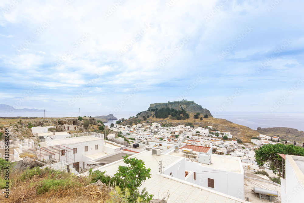 Obraz premium A small town in Rhodes Greece with ruins in background