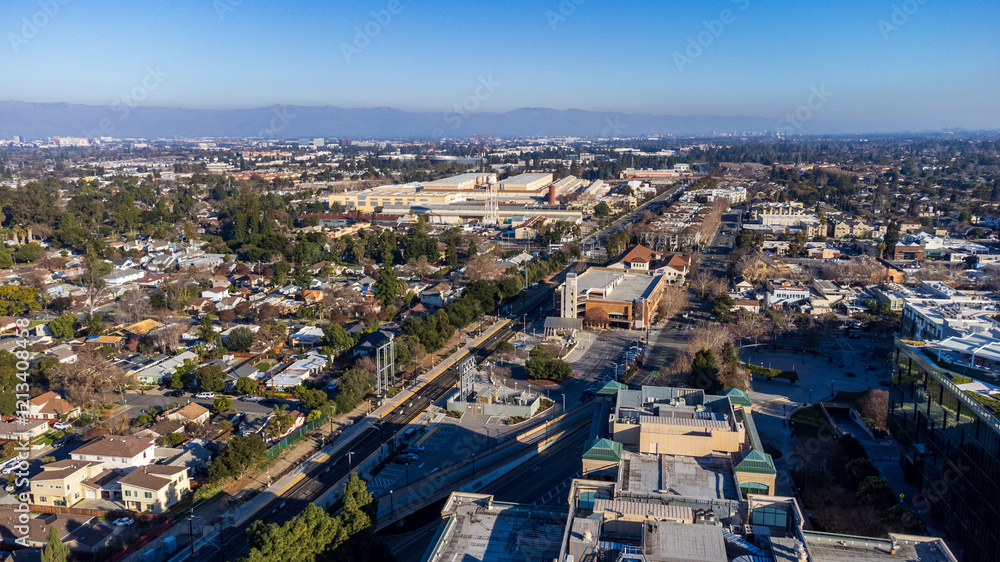 Fototapeta premium Aerial view of a train station in downtown Sunnyvale surrounded by residential neighborhoods, commercial buildings