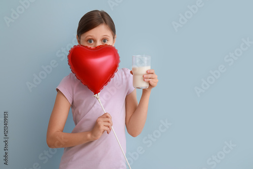 Little girl with glass of m...