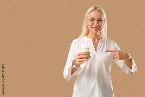 Smiling mature woman pointi...