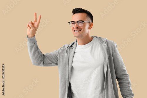 Young man showing victory g...
