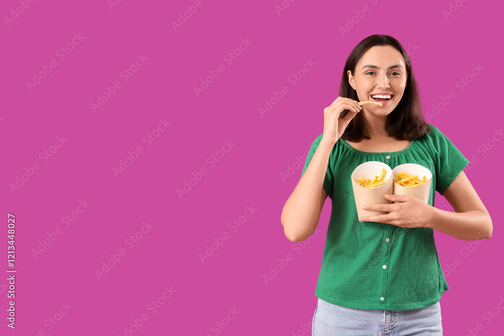 Young woman eating french fries on purple background Young woman eating french fries on purple background