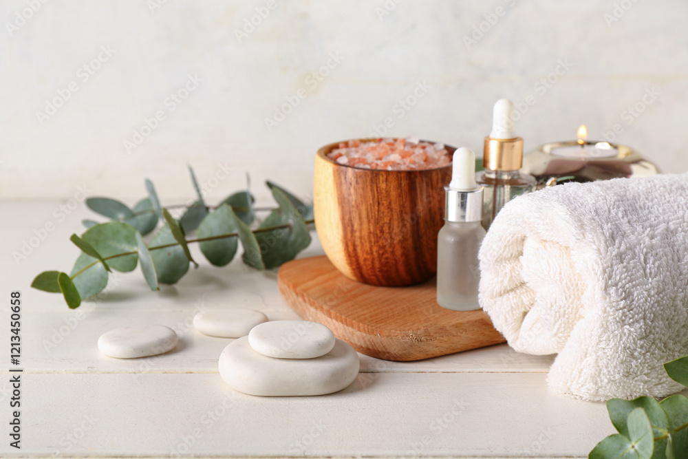 Spa composition with eucalyptus branches on light wooden table Spa composition with eucalyptus branches on light wooden table