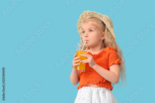 Adorable little girl drinki...