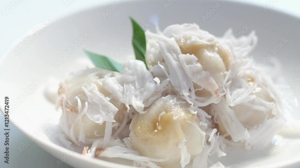 Kanom Tum or Coconut ball is Delicious dessert. Sweet dessert served with coconut slide. Thai dessert. Kanom Tum or Coconut ball is Delicious dessert. Sweet dessert served with coconut slide. Thai dessert.