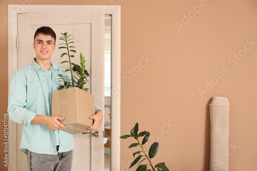 Young man with moving box a...