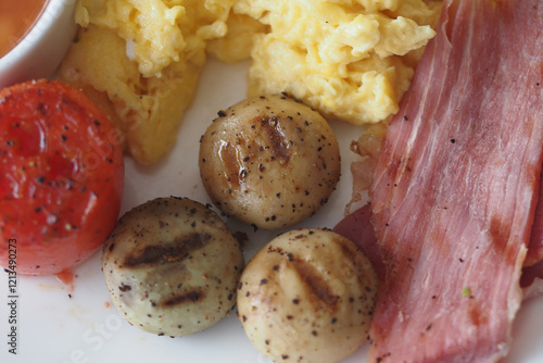 Delicious Breakfast Plate with Eggs, Bacon, and Grilled Vegetables photo