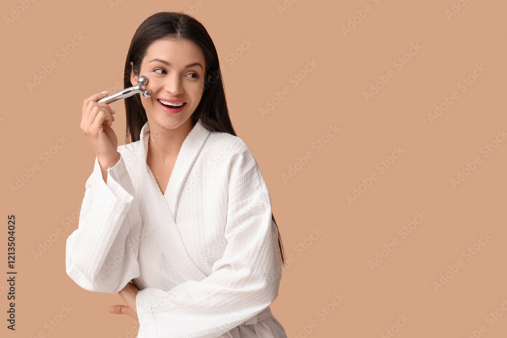 Pretty young woman with face massage roller on beige background Pretty young woman with face massage roller on beige background