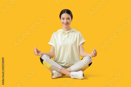 Sporty young woman meditati...