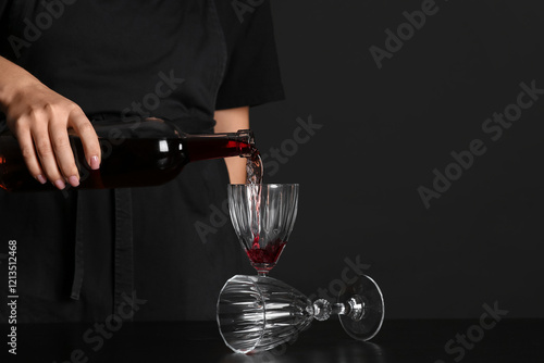 Bartender pouring red wine ...