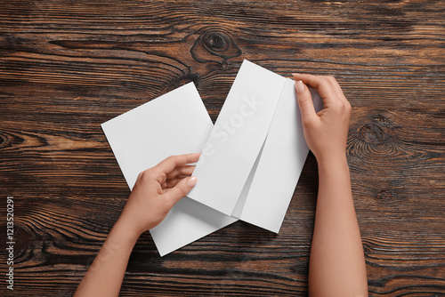 Hands opening blank white p...