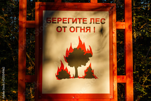 Warning sign in a forest park with the inscription in Russian Protect the forest from fire, Russia photo