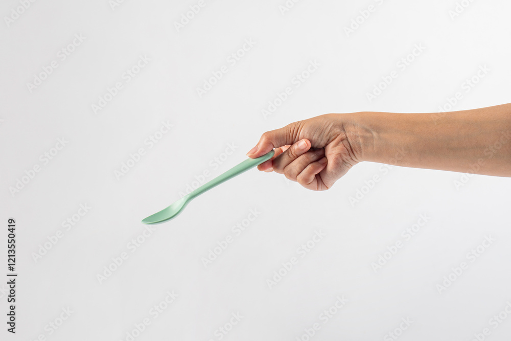 Green spoon and hand isolated on white background. Green spoon and hand isolated on white background.