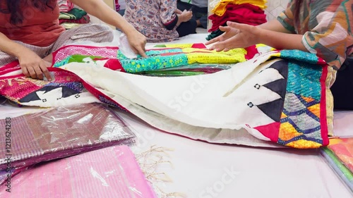 Buyer takes a garment from the collection for checking it