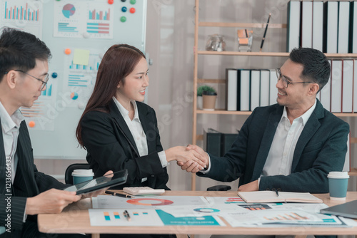 Shaking hands of people working in the office Business deals, partnerships, and we are hiring a female HR manager who is ready to welcome any new business start-up. photo