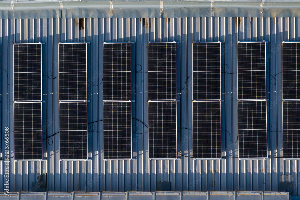 Aerial view of solar panels installed on a rooftop in a commercial area, showcasing renewable energy and sustainability. Photovoltaic energy industry.