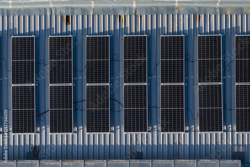 Obraz na płótnie Aerial view of solar panels installed on a rooftop in a commercial area, showcasing renewable energy and sustainability. Photovoltaic energy industry. w salonie