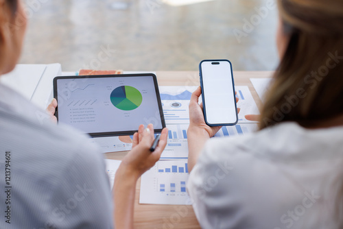 Close up Business woman using calculator and laptop and phone for do math finance on wooden desk, tax, accounting, statistics and analytical research concept photo