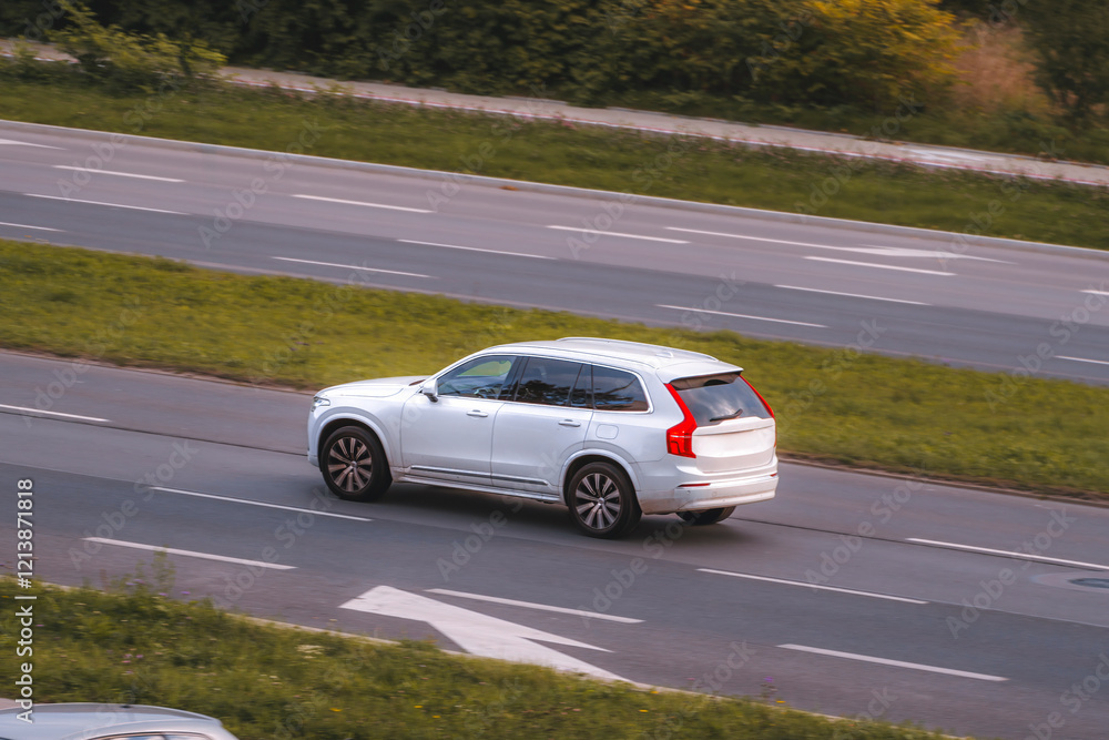 Modern family SUV driving on countryside road Modern family SUV driving on countryside road