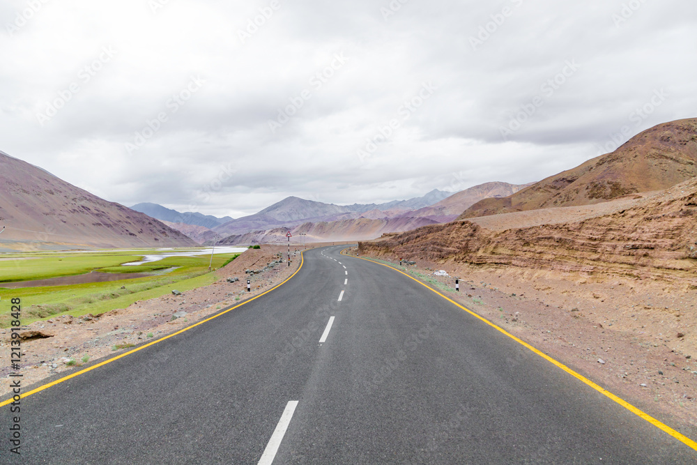 Empty road in wilderness area, in Nyoma Village with Indus river, in Ladakh, India. Empty road in wilderness area, in Nyoma Village with Indus river, in Ladakh, India.
