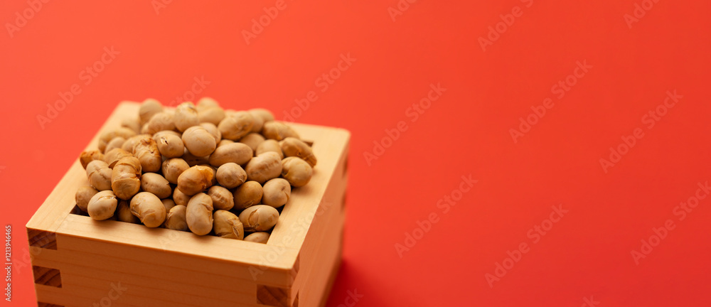 Japanese event, Setsubun. Soybeans for bean-sowing placed on a red background. 日本の行事。節分。赤背景上に置かれた豆まき用の大豆。 Japanese event, Setsubun. Soybeans for bean-sowing placed on a red background. 日本の行事。節分。赤背景上に置かれた豆まき用の大豆。