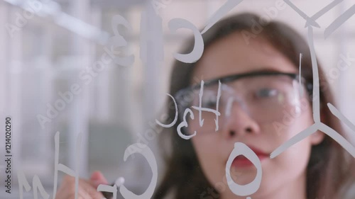 Scientist or researcher is writing something on board