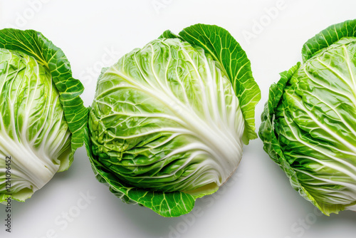 Three fresh Chinese cabbages with vibrant green leaves and crisp white stems arranged on a white background. The detailed texture and natural color contrast highlight their freshness.
 photo