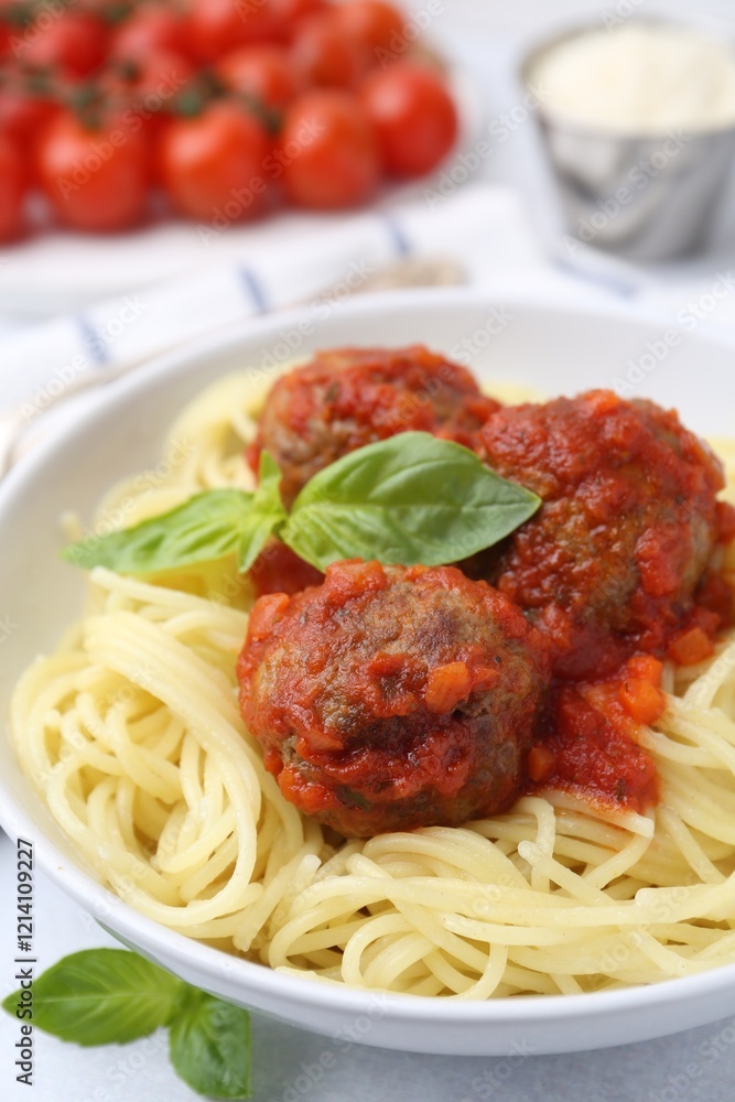 Delicious pasta with meatballs in bowl on light table, closeup Delicious pasta with meatballs in bowl on light table, closeup