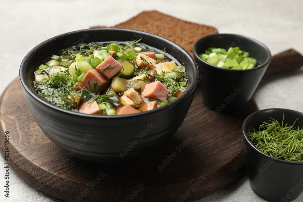 Delicious okroshka soup with kvass and ingredients on light table, closeup Delicious okroshka soup with kvass and ingredients on light table, closeup