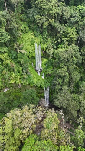 Aerial footage of the Tiu Kelep Waterfall on a sunny day in North Lombok Regency, Indonesia photo