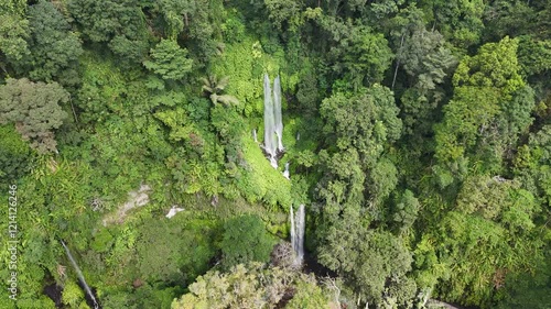 Aerial footage of the scenic Tiu Kelep Waterfall on a sunny day in North Lombok Regency, Indonesia photo