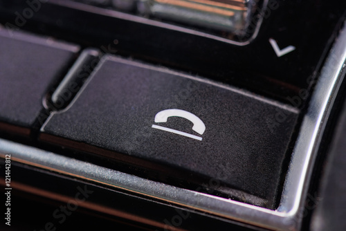 фотографія The hang-up button on the car panel of a passenger car dashboard.