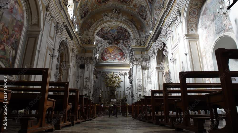 Low angle view walking past wooden pew chairs towards imposing altar in beautifully decorated San Benedetto church in Catania, Italy
Low angle view walking past wooden pew chairs towards imposing altar in beautifully decorated San Benedetto church in Catania, Italy