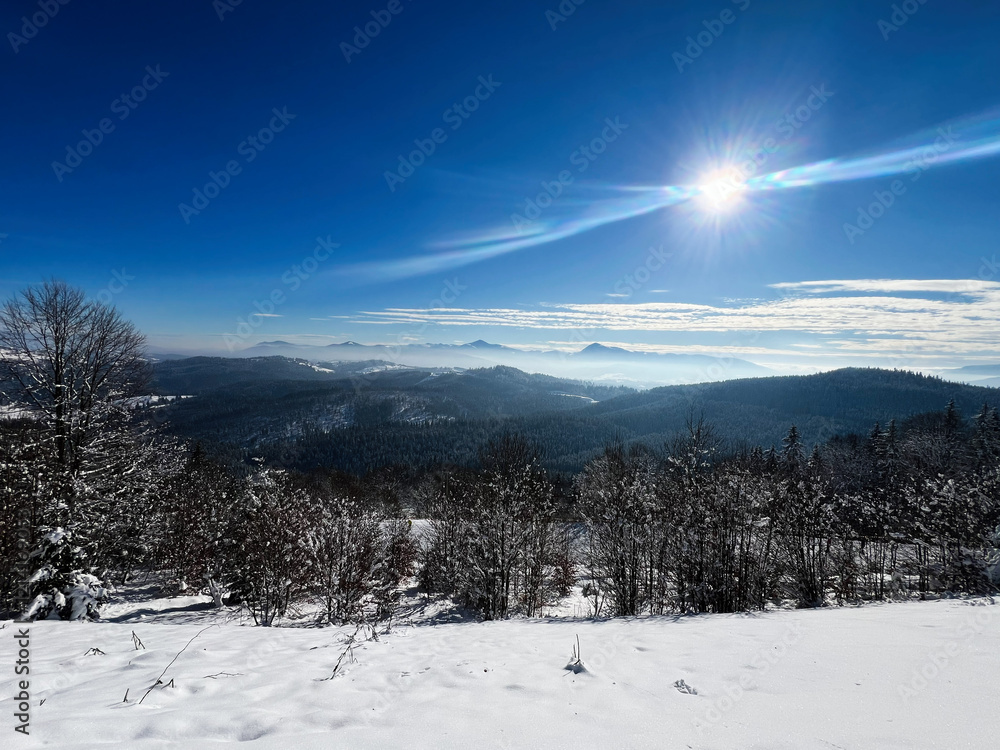 Snowy mountain landscape with bright sunshine under a clear blue sky Snowy mountain landscape with bright sunshine under a clear blue sky