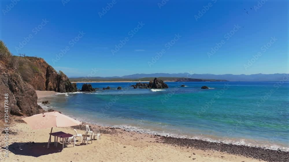 Small waves slowly smash on the white sand beach of La Morita, Tenacatita, Mexico. Coral reef bay at low tide perfect for snorkeling Small waves slowly smash on the white sand beach of La Morita, Tenacatita, Mexico. Coral reef bay at low tide perfect for snorkeling