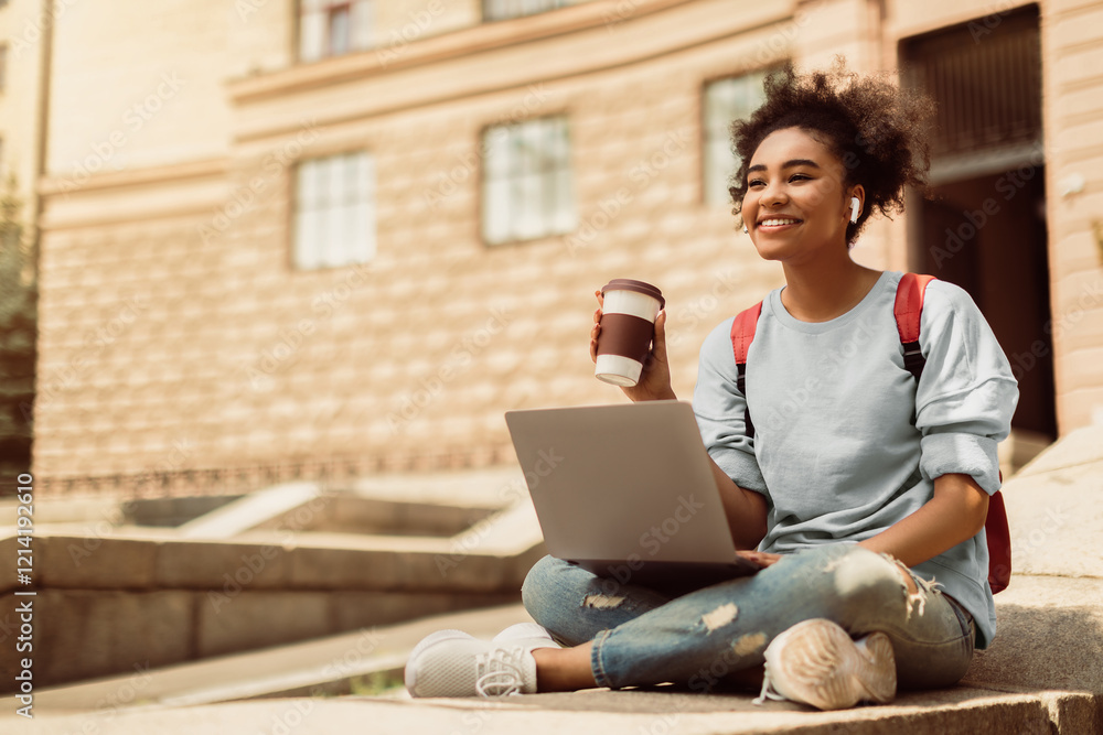 E-Learning. Happy African American Student Girl Using Laptop Holding Coffee Learning Online Sitting Outdoors, Wearing Earphones. Distance College Education Concept. Copy Space E-Learning. Happy African American Student Girl Using Laptop Holding Coffee Learning Online Sitting Outdoors, Wearing Earphones. Distance College Education Concept. Copy Space