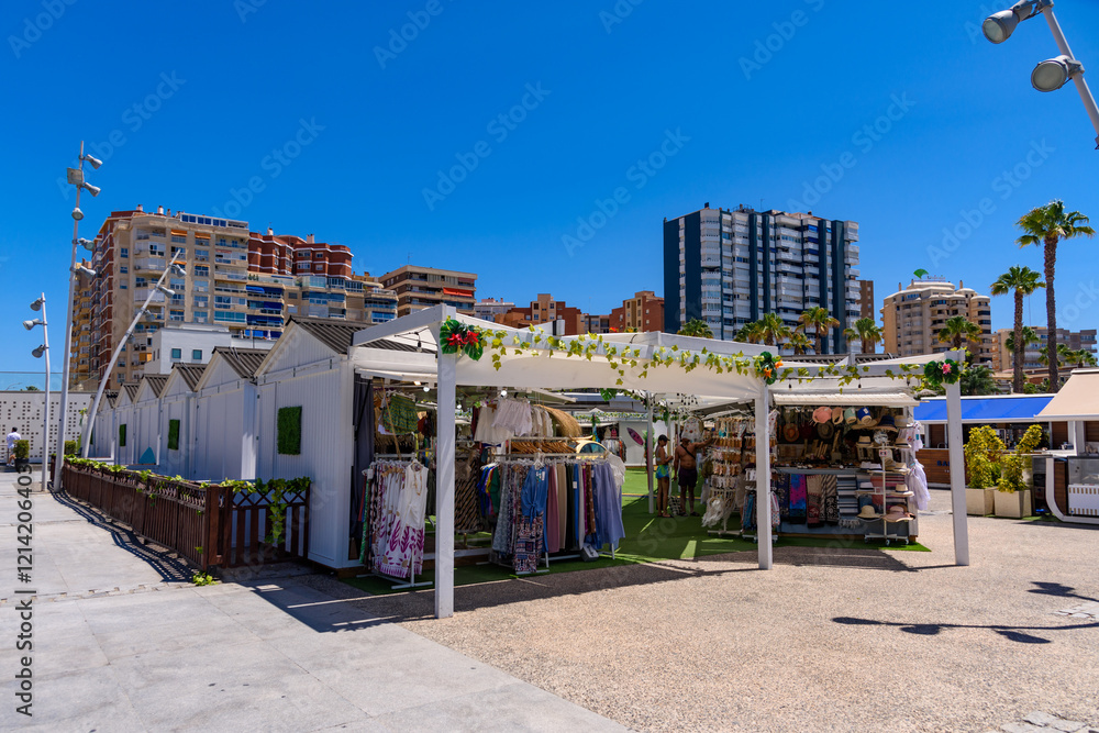 Malaga, Spain - August 06, 2024: Palmeral de las Sorpresas promenade in seaport. Malaga, Andalusia