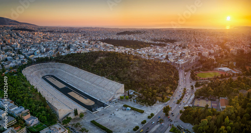 Fototapeta Naklejka Na Ścianę i Meble -  Aerial view of the skyline of Athens, Greece, with the historic Panathenaic Stadium during sunset time