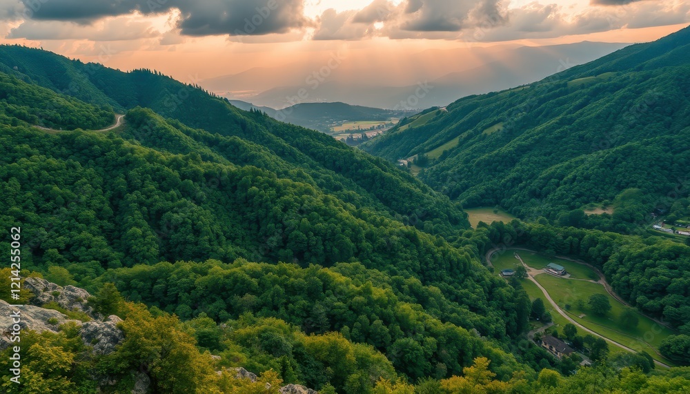 Fototapeta premium Sunset Over Lush Green Mountain Valley Landscape