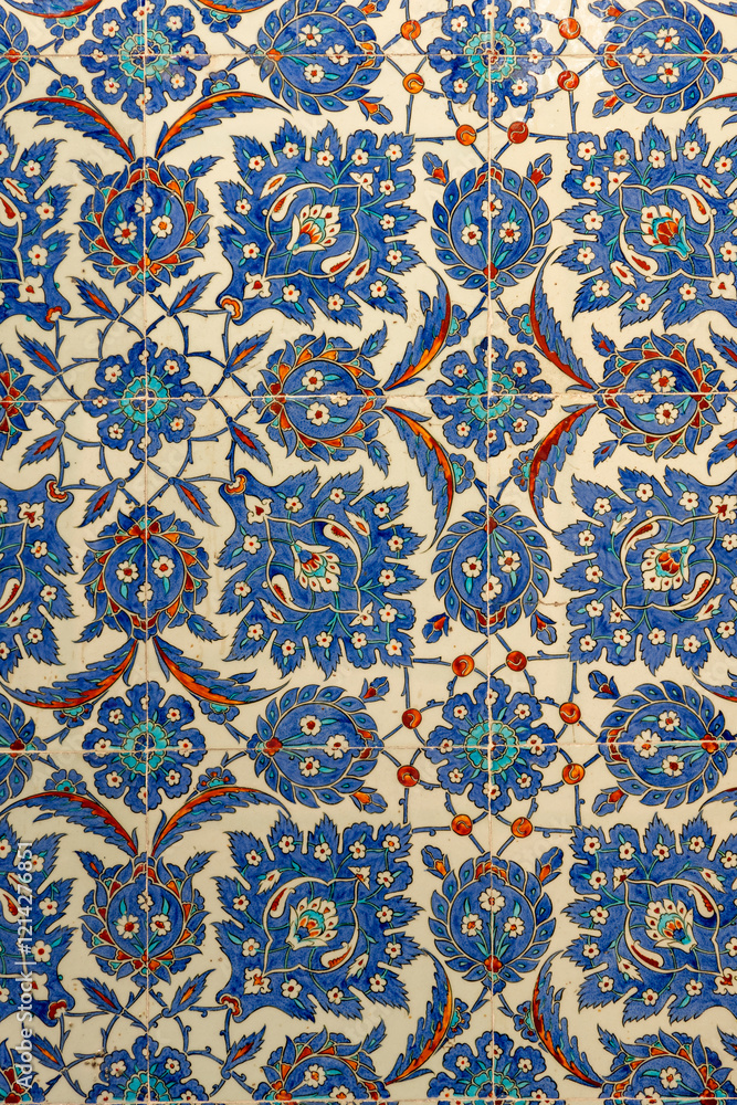A close up of traditional Ottoman Iznik tiles featuring floral and geometric patterns in blue, red and white. This historical ceramic art reflects rich Turkish heritage A close up of traditional Ottoman Iznik tiles featuring floral and geometric patterns in blue, red and white. This historical ceramic art reflects rich Turkish heritage