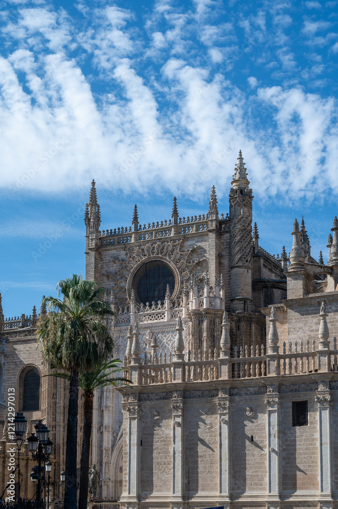 Fototapeta premium Walking in old historical Andalusian town Seville, Cathedral church, Spain. View on houses, streets, architectural details of buidings. Summer in Andalusia.