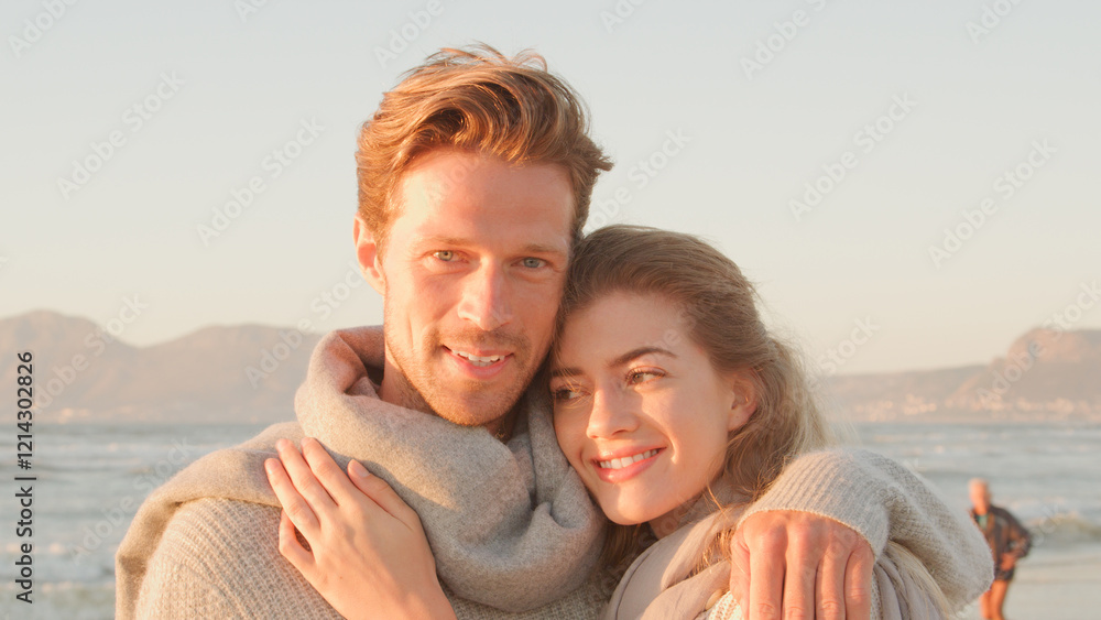 Head And Shoulders Portrait Of Loving Couple Hugging On Winter Beach With Golden Light Head And Shoulders Portrait Of Loving Couple Hugging On Winter Beach With Golden Light