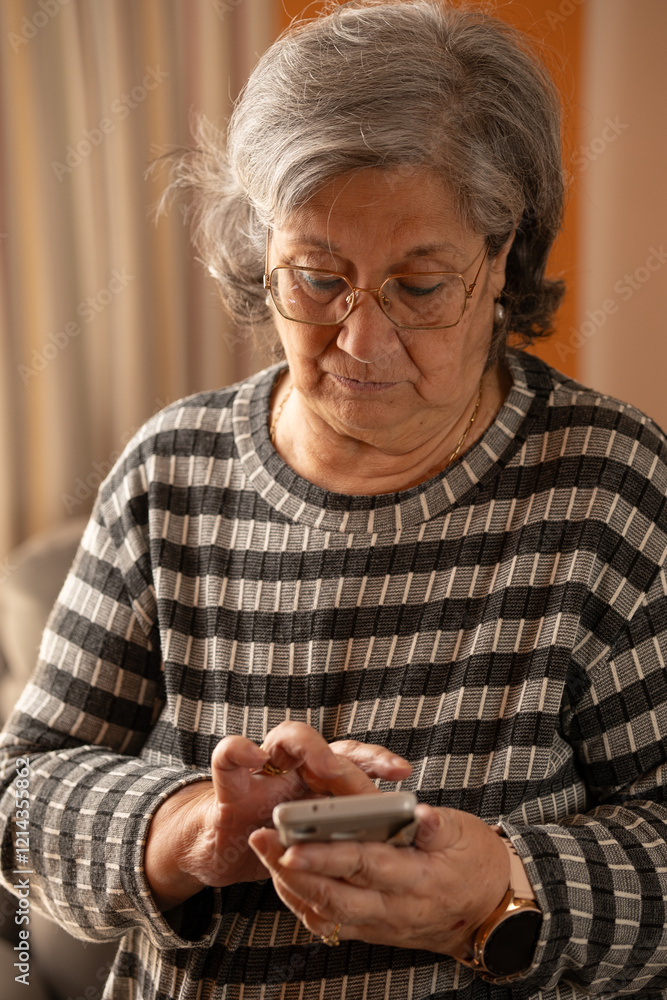 close-up of an older woman sending a message with her cell phone close-up of an older woman sending a message with her cell phone