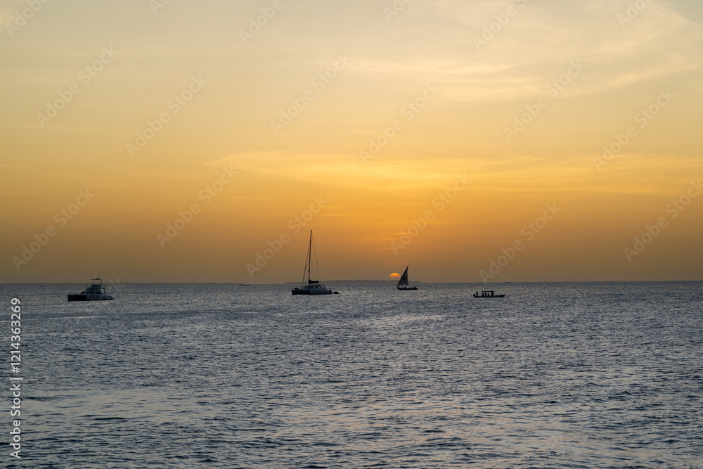 Boats and Sun Dipping Below the Horizon in Zanzibar Boats and Sun Dipping Below the Horizon in Zanzibar